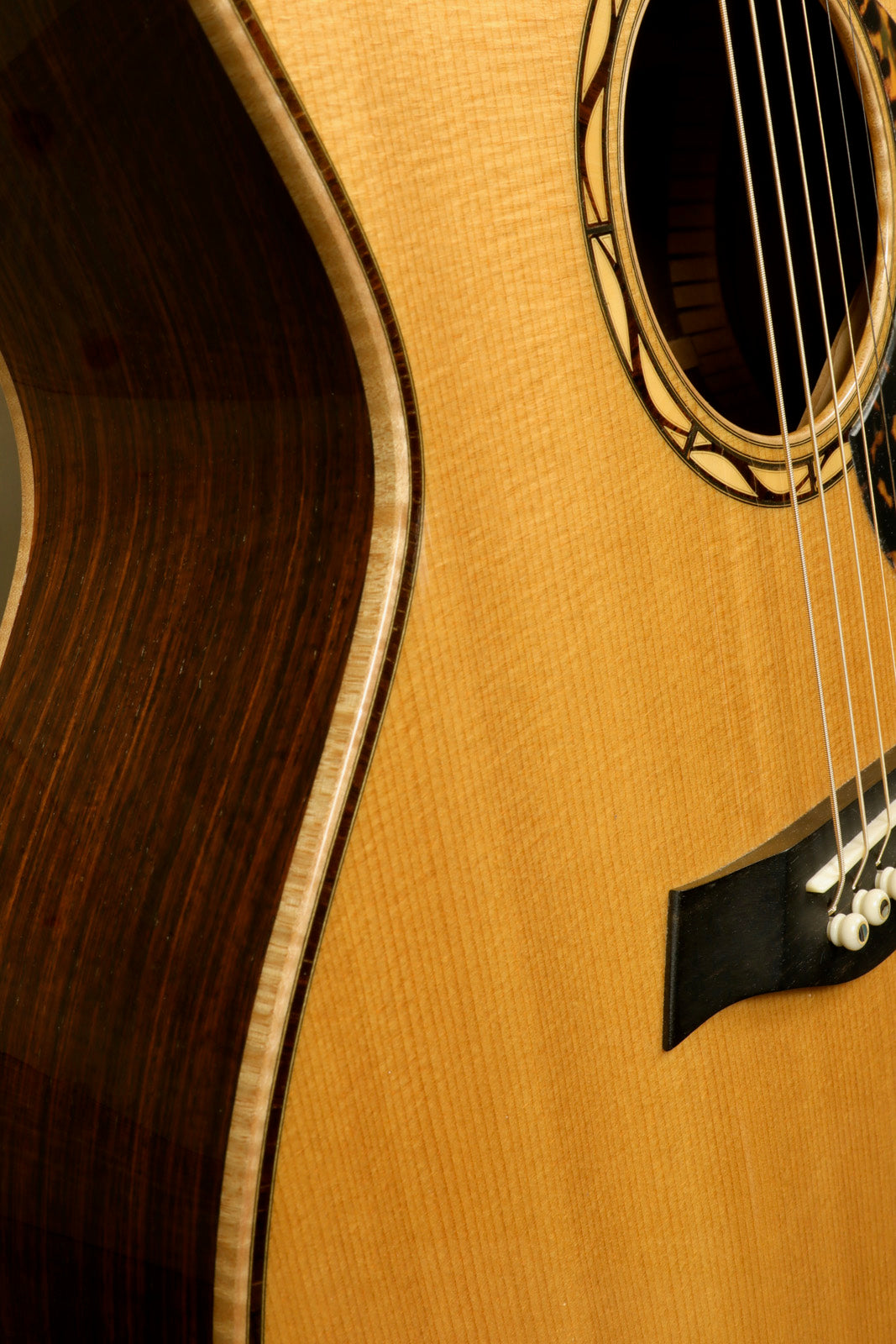 Close-up view of a used Taylor Cocobolo GA LTD guitar showcasing its wood grain and craftsmanship