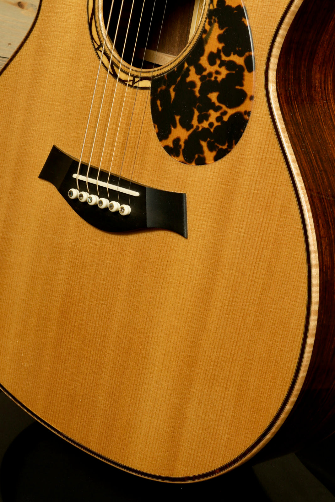 Close-up of a used Taylor Cocobolo GA LTD guitar showcasing its elegant finish and detailed soundhole design