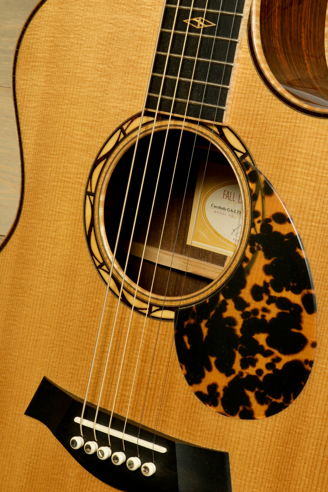 Close-up of a used Taylor Cocobolo GA LTD guitar showcasing its elegant finish and intricate details