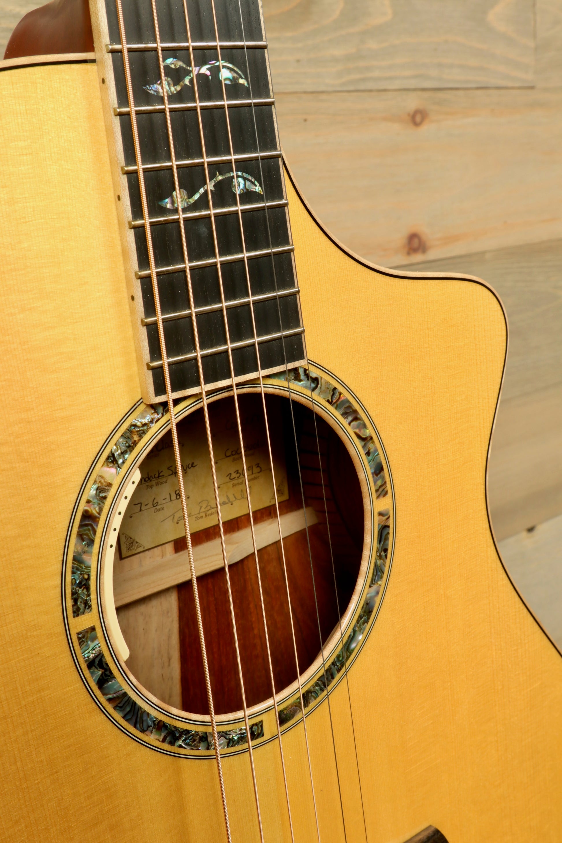 Close-up of a used Breedlove Masterclass Concert guitar showcasing intricate inlays and a polished finish