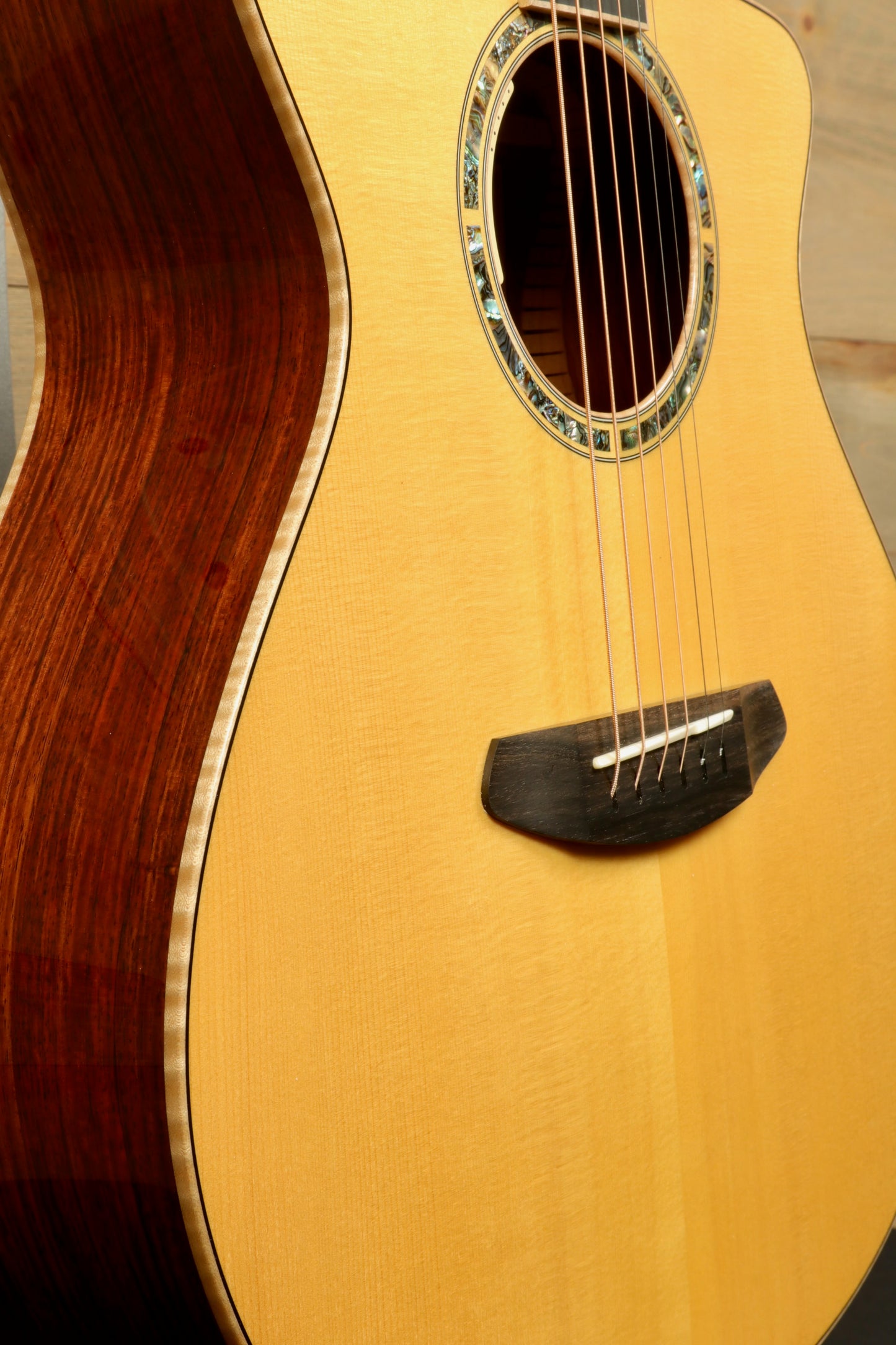 Close-up of a used Breedlove Masterclass Concert guitar showcasing its beautiful wood grain and detailed craftsmanship