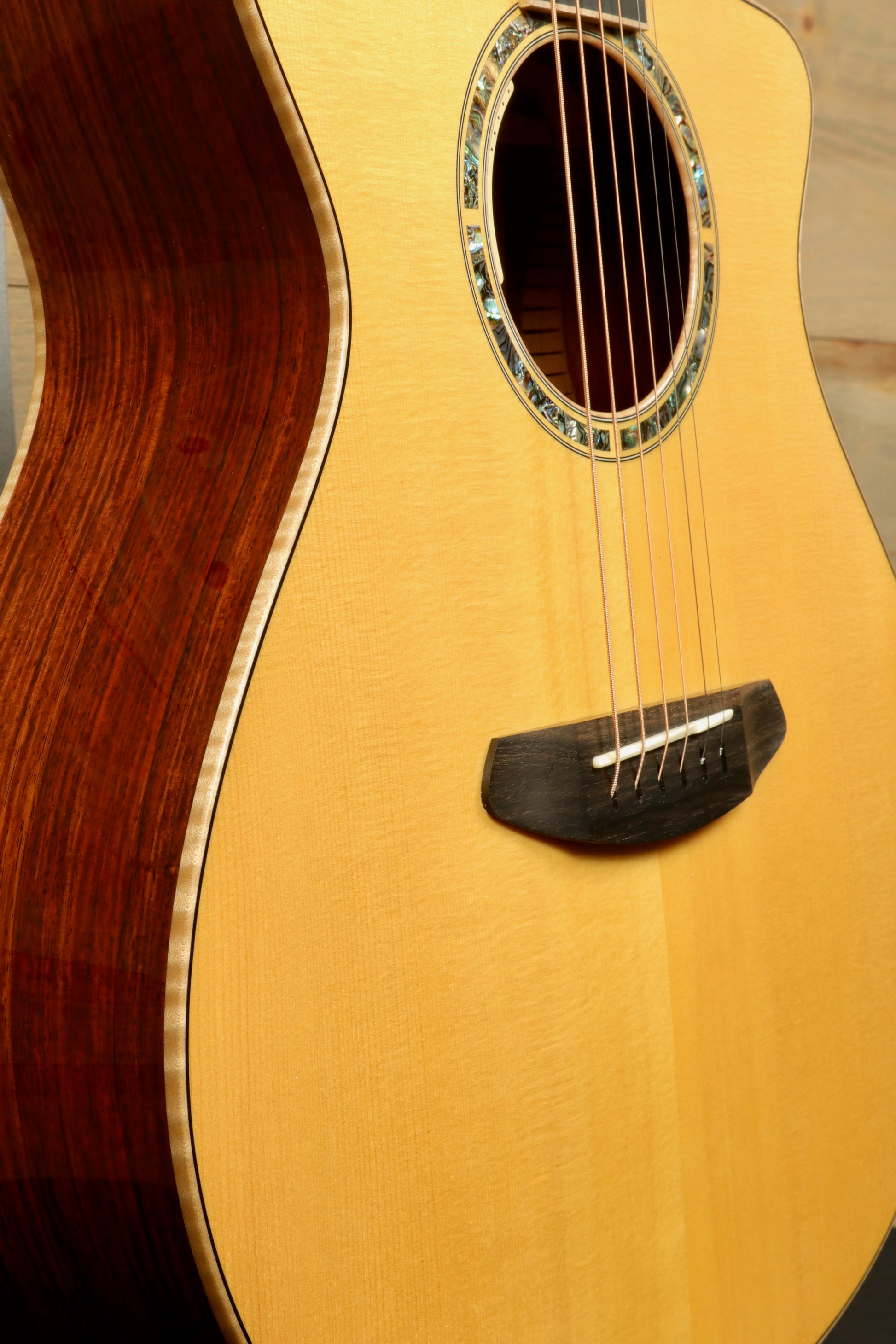 Close-up of a used Breedlove Masterclass Concert guitar showcasing its beautiful wood grain and detailed craftsmanship