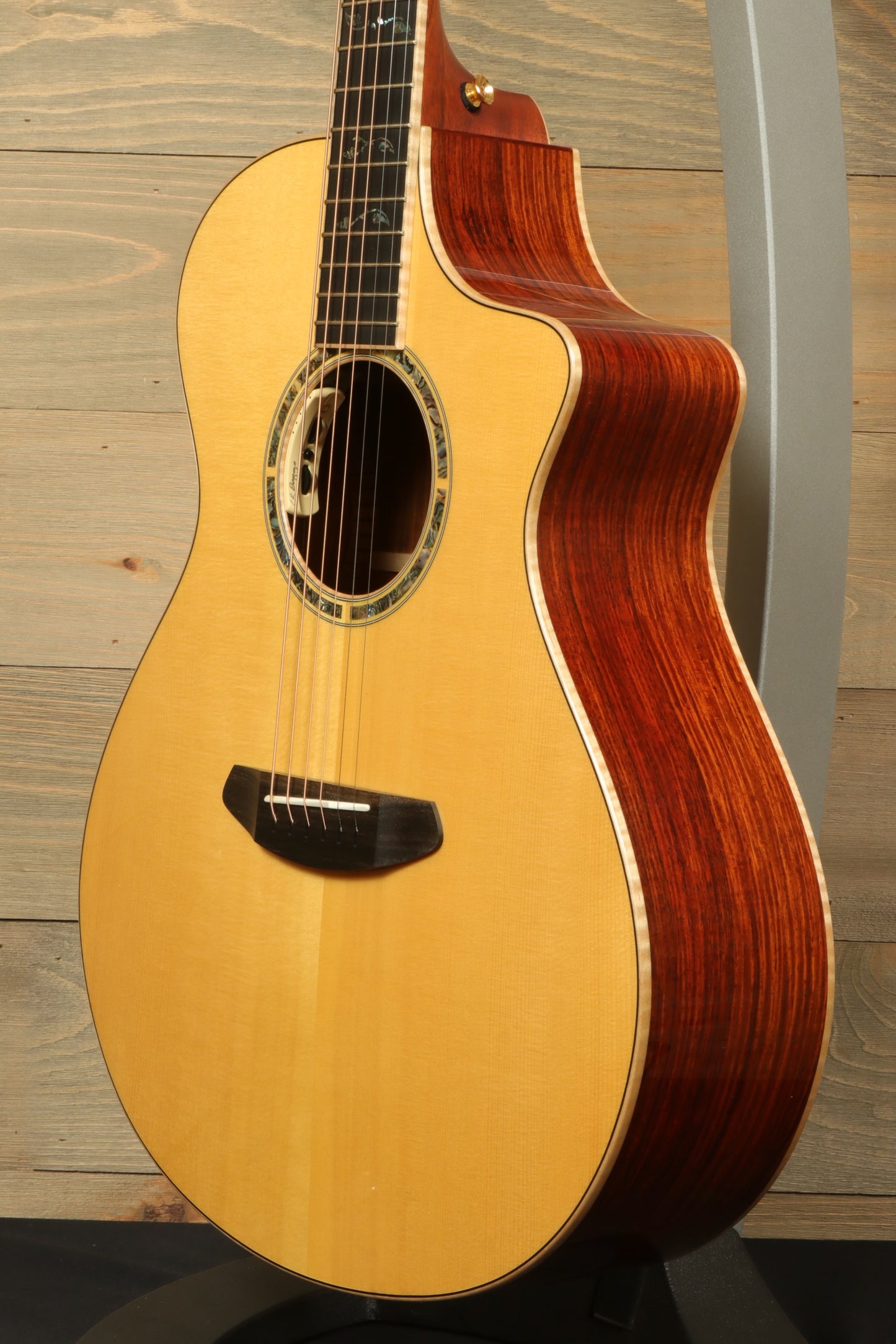 Side view of a used Breedlove Masterclass Concert guitar showcasing its beautiful wood grain and craftsmanship