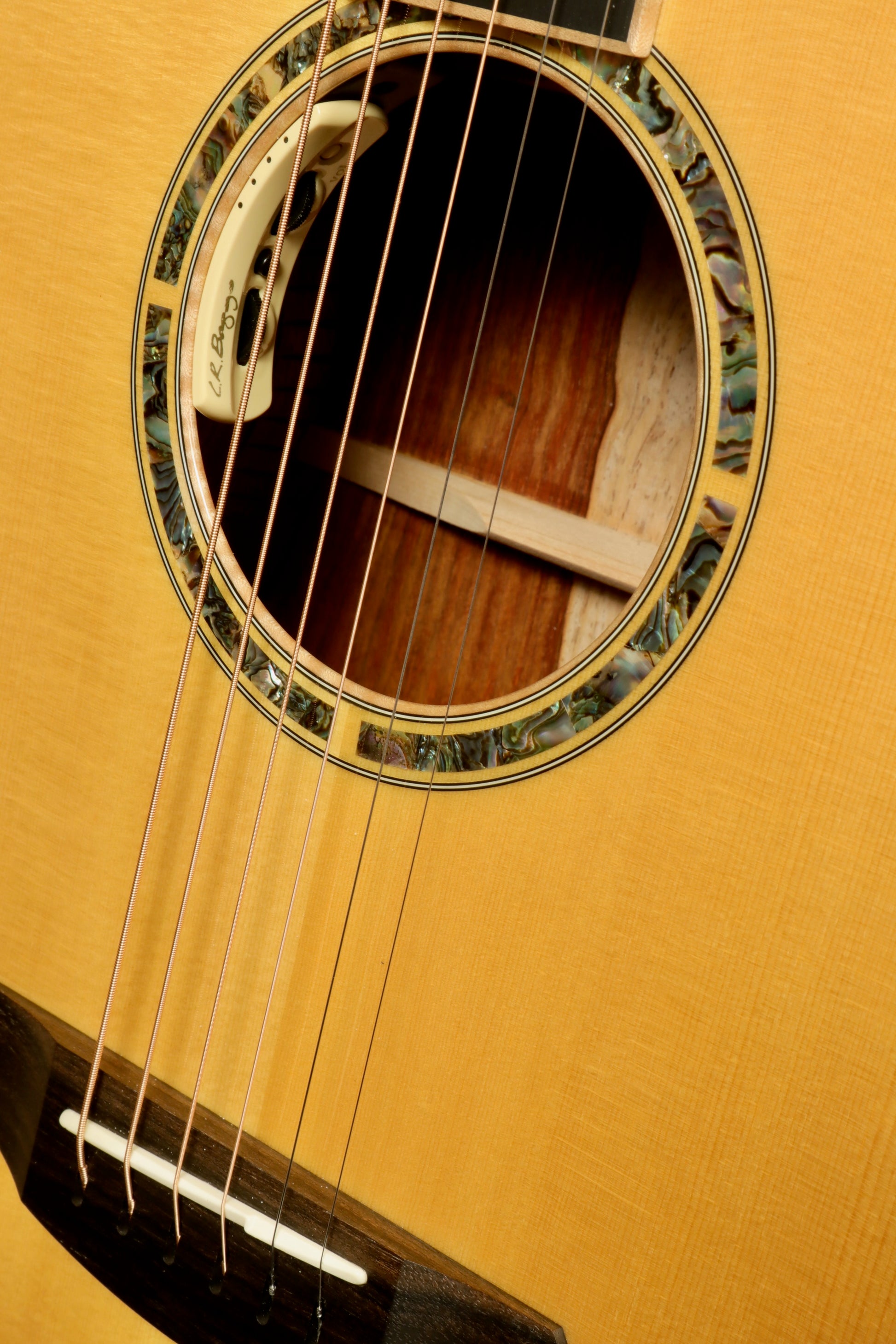 Close-up of a used Breedlove Masterclass Concert guitar showcasing intricate rosette and strings