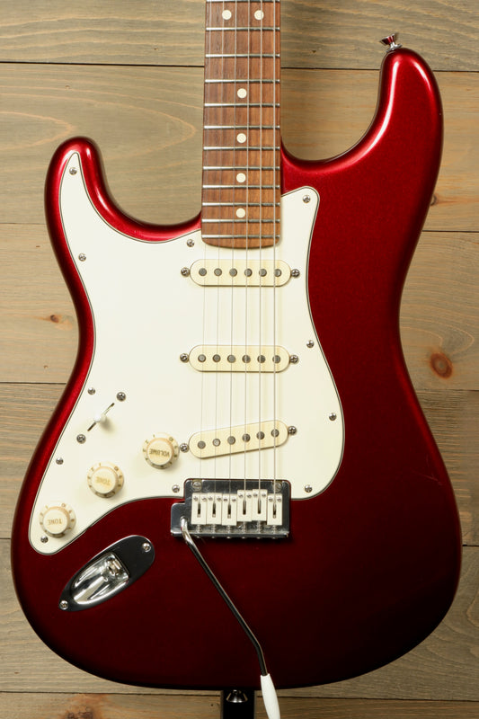 Used Fender Stratocaster left handed guitar in metallic red finish with white pickguard