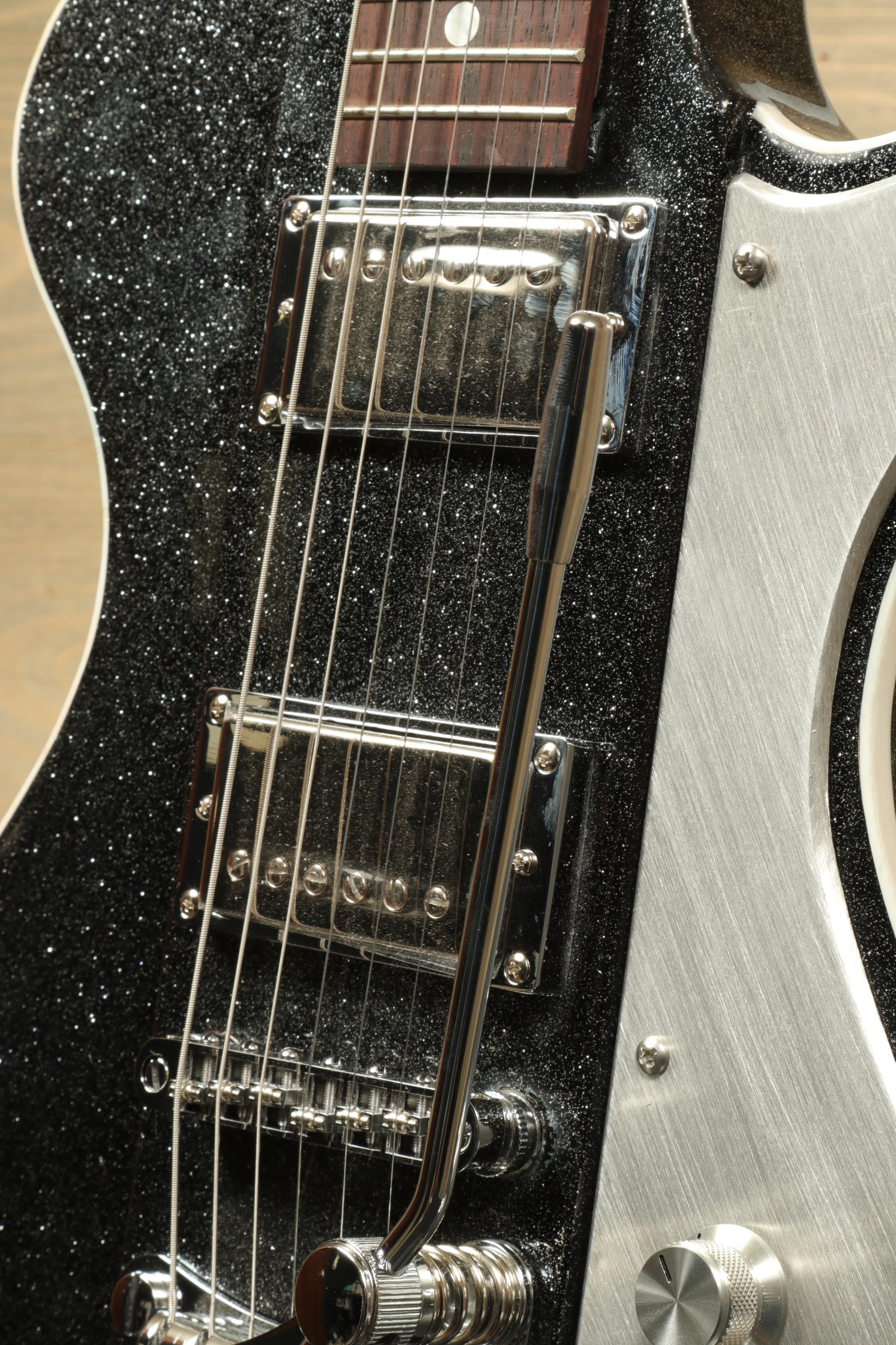 Weller Fleetwood Tremolo electric guitar in black sparkle finish, side view showcasing hardware and tremolo arm