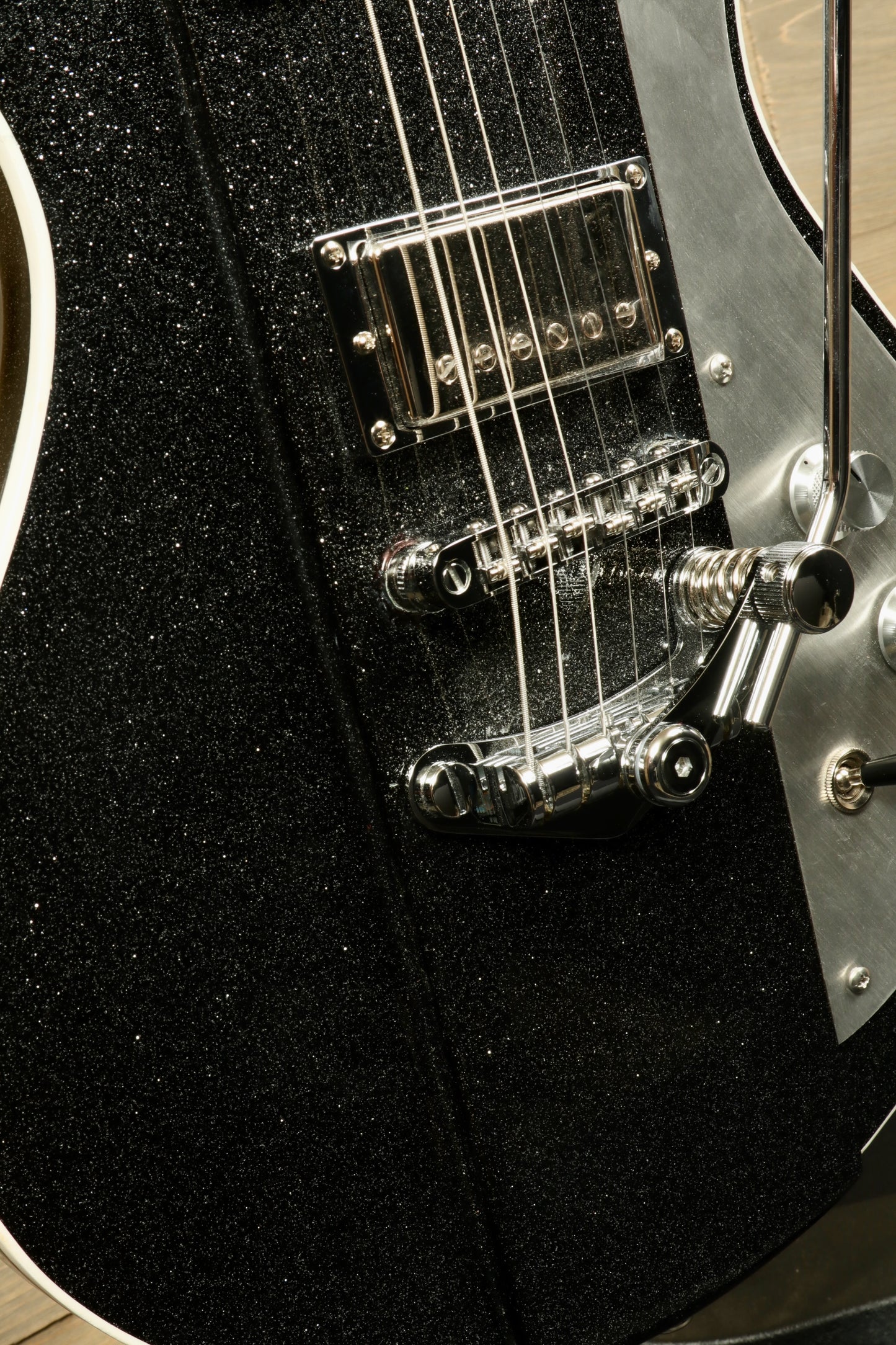 Weller Fleetwood Tremolo electric guitar in black sparkle finish, close-up view of tremolo system