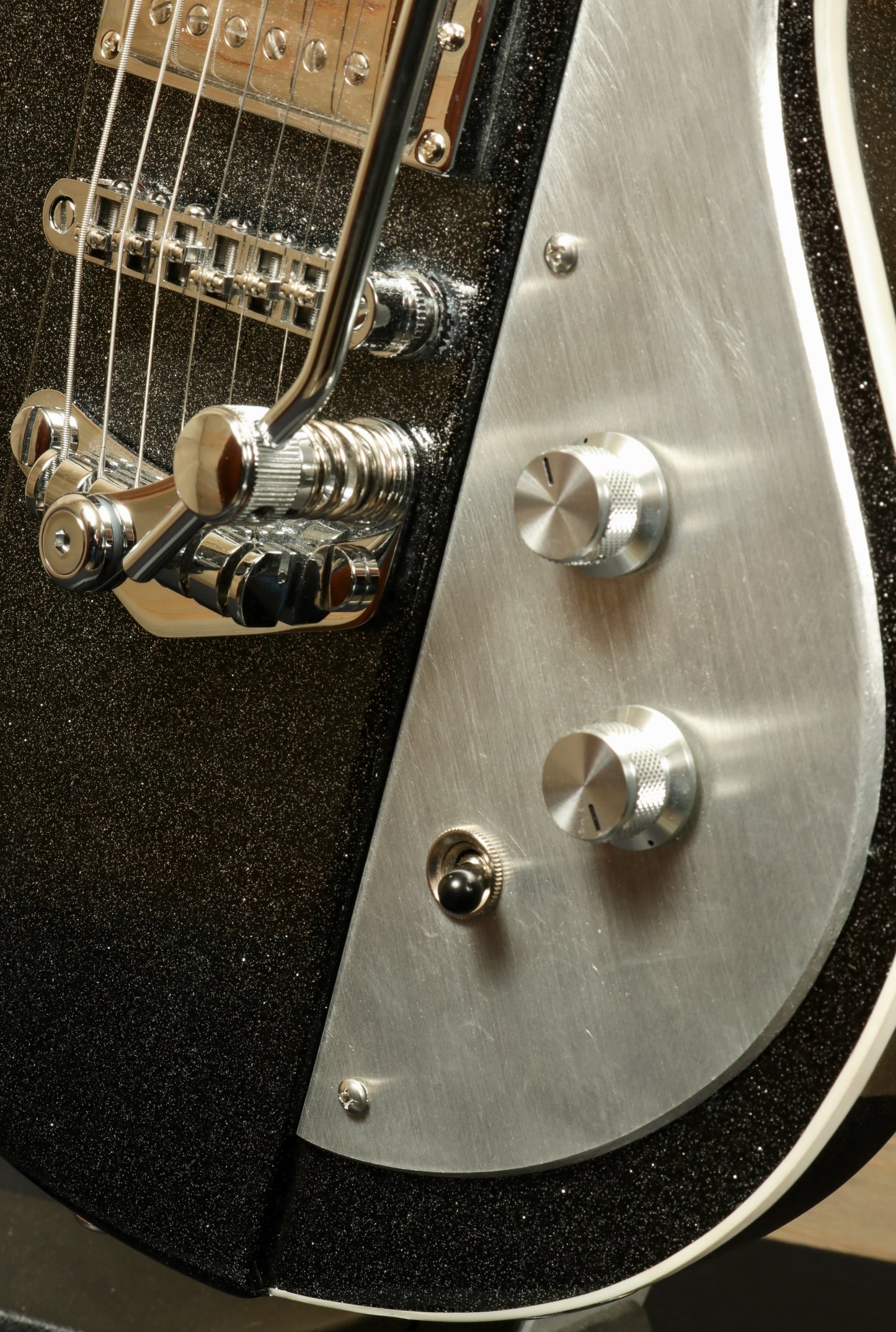 Weller Fleetwood Tremolo electric guitar in black sparkle finish, close-up view of bridge and control knobs