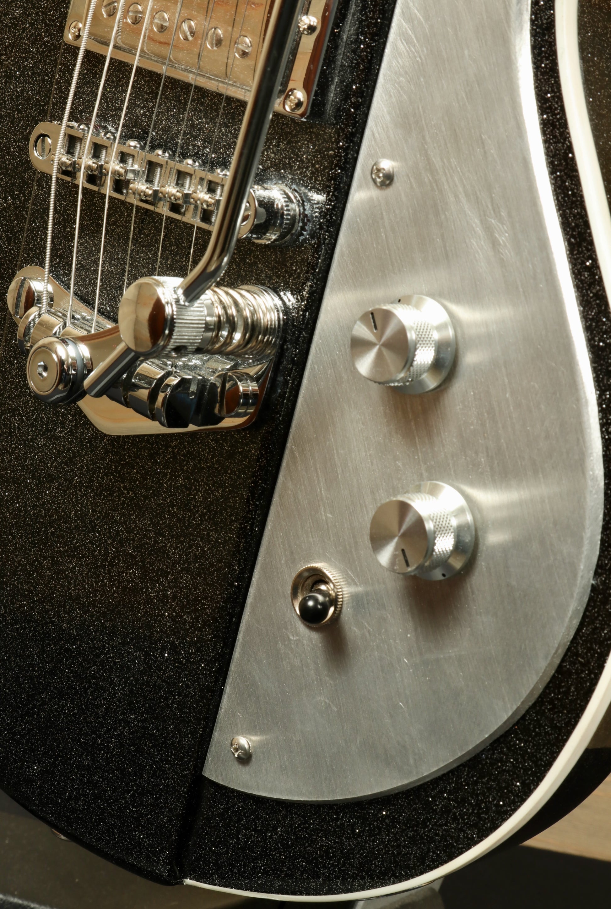 Weller Fleetwood Tremolo electric guitar in black sparkle finish, close-up view of bridge and control knobs
