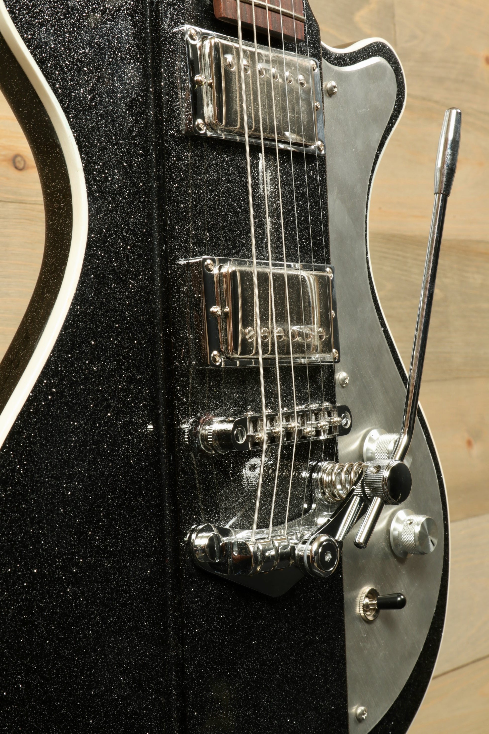 Weller Fleetwood Tremolo electric guitar in black sparkly finish, side view showcasing tremolo arm and pickups