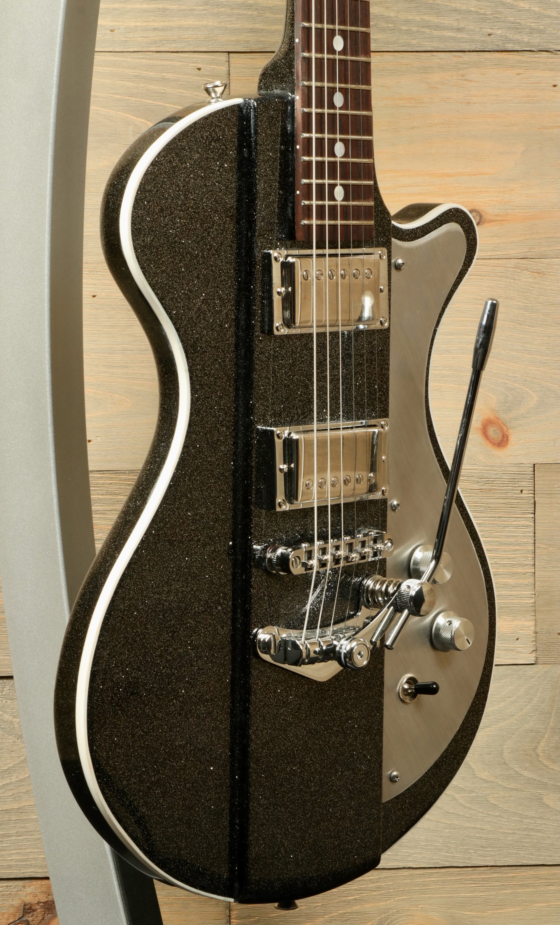 Weller Fleetwood Tremolo electric guitar in black glitter finish, side view showcasing controls and pickups