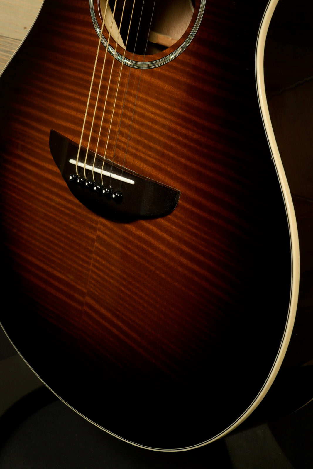 Yamaha APX600 FM acoustic electric guitar in sunburst finish, side view with gig bag