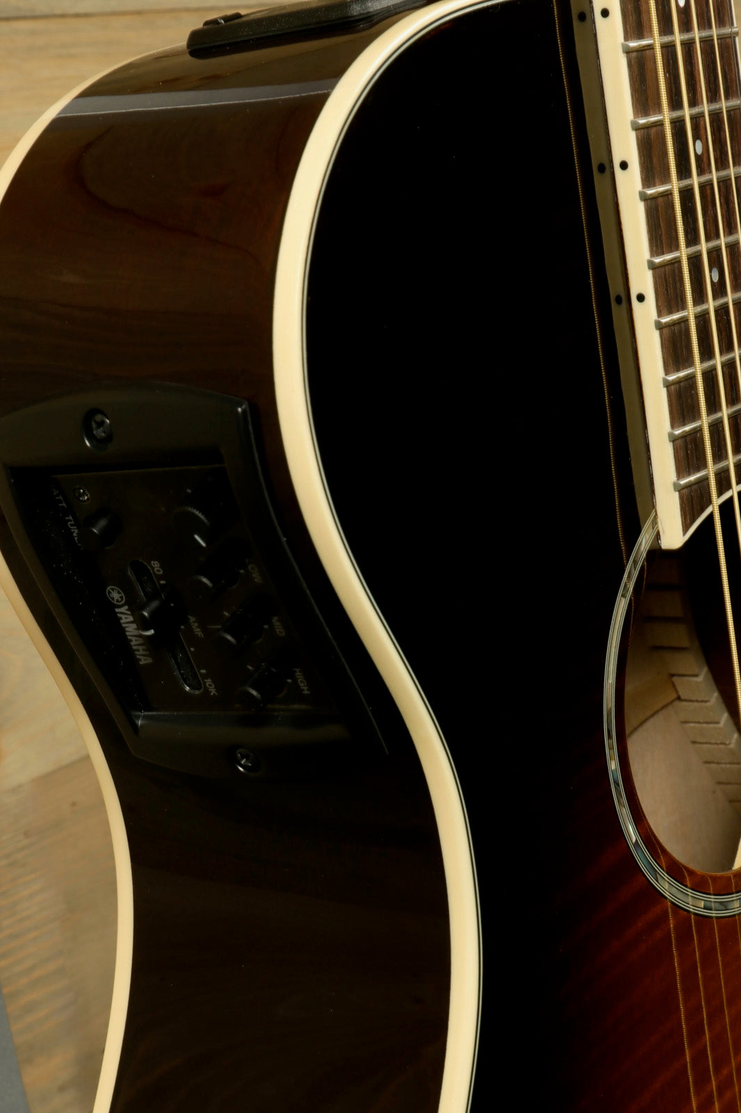 Yamaha APX600 FM Acoustic Electric Guitar in dark finish with RoadRunner Gig Bag, side view