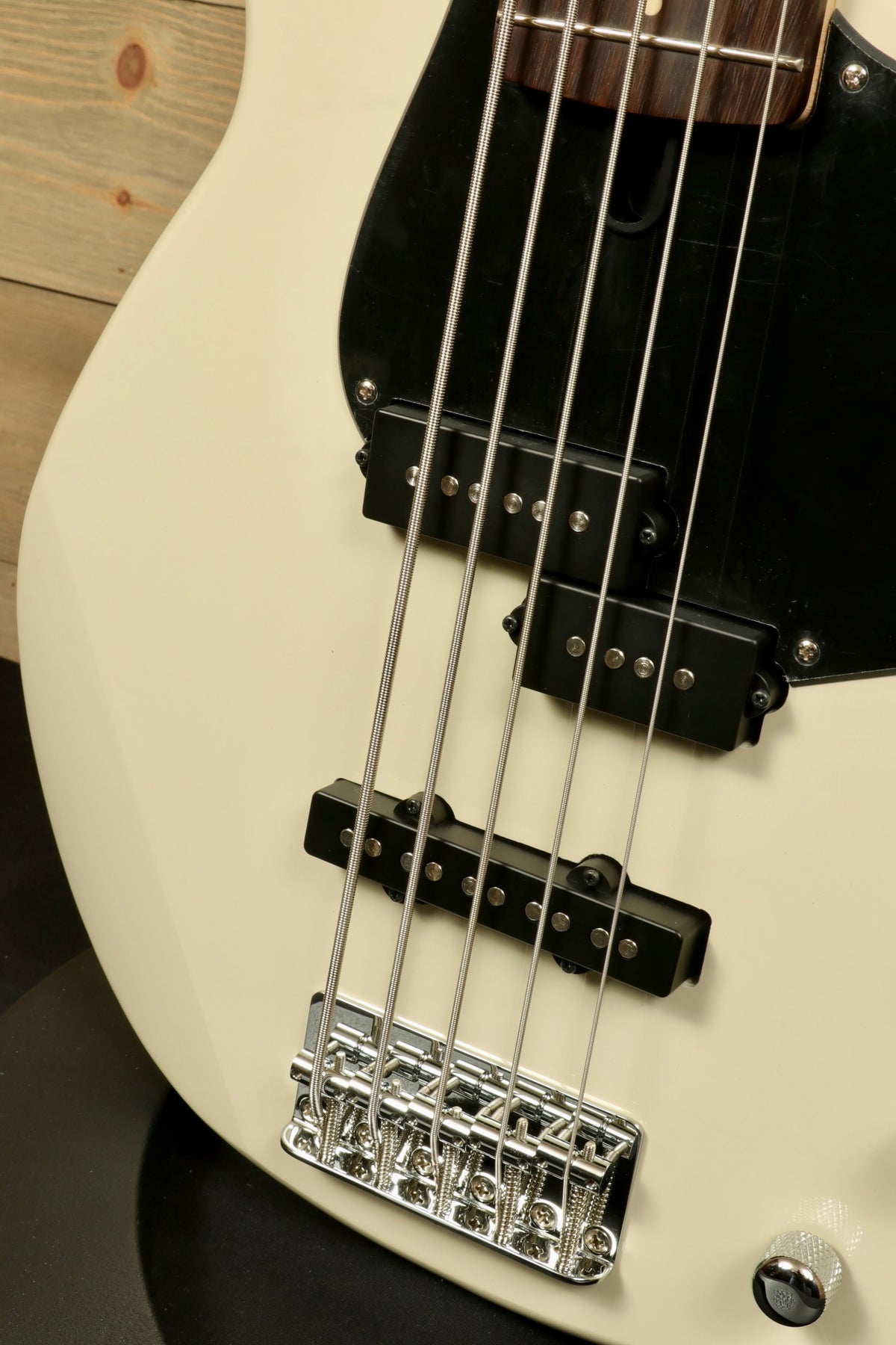 Yamaha BB235 5-String Electric Bass Guitar in white, close-up view of strings and bridge