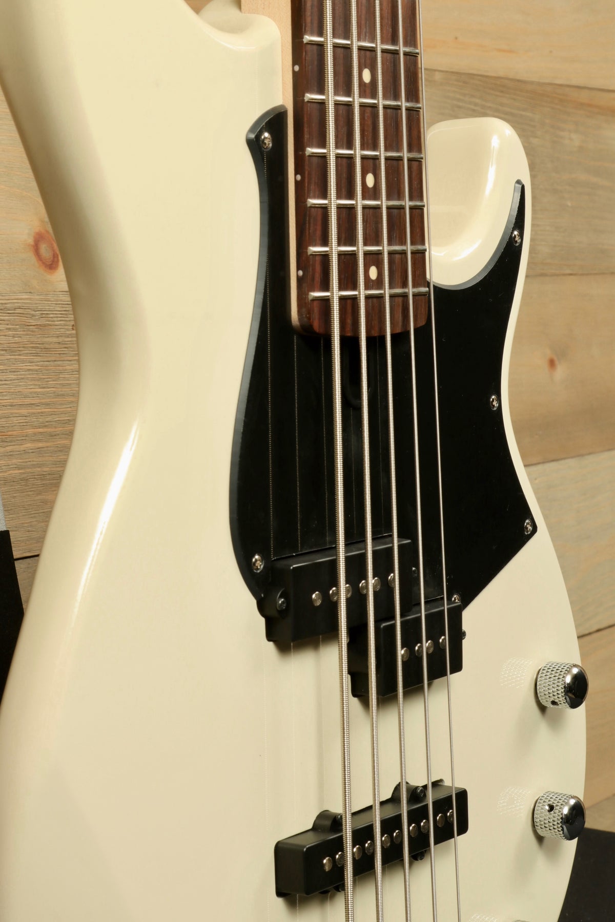 Yamaha BB235 5-String Electric Bass Guitar in white with a sleek design, side view showcasing the neck and body