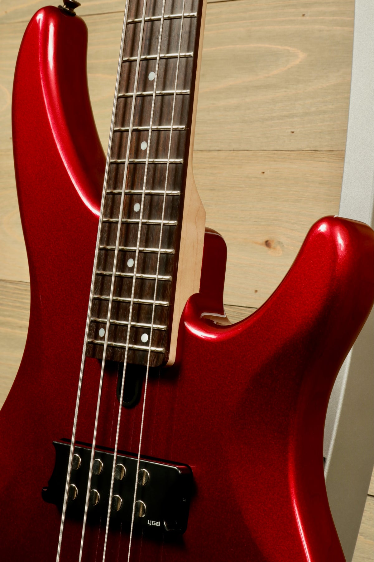 Yamaha electric bass guitar in metallic red finish, front view showcasing its sleek design
