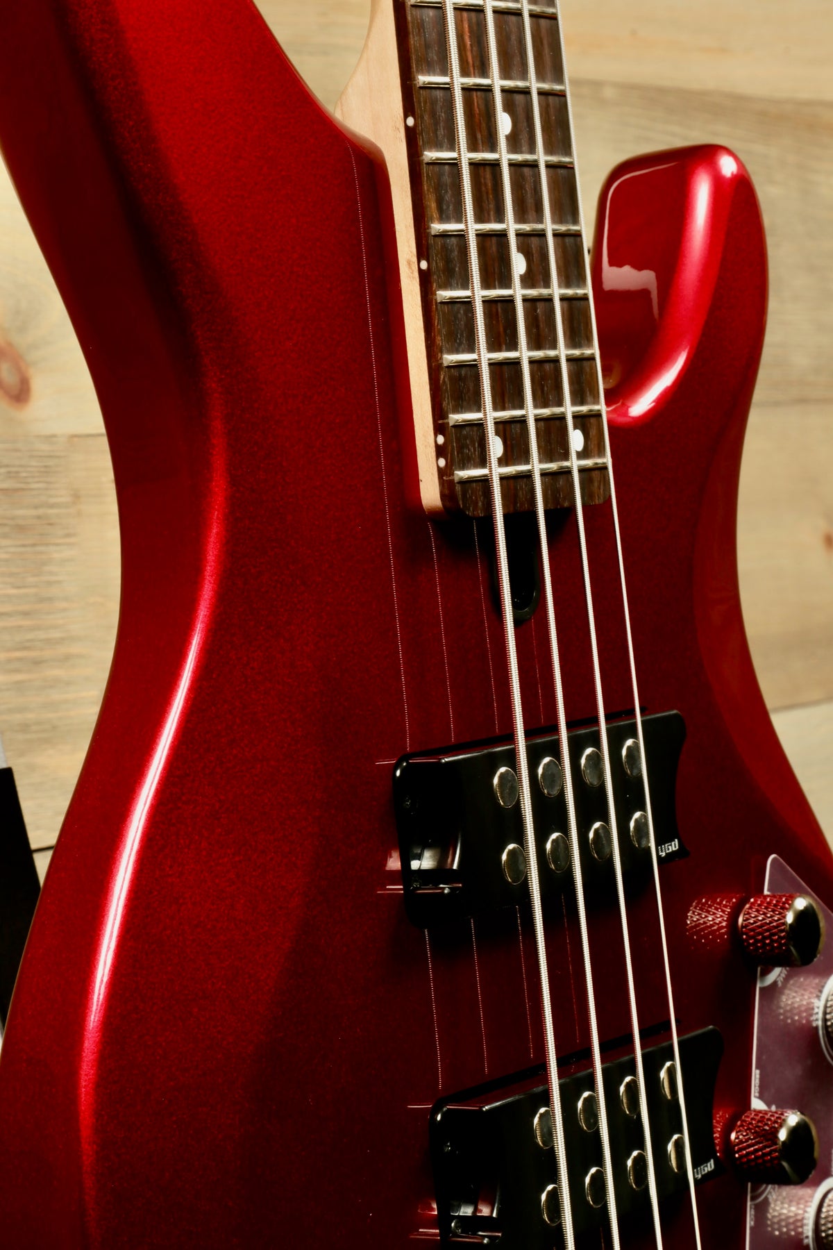Yamaha electric bass guitar in red finish, side view showcasing sleek design and hardware