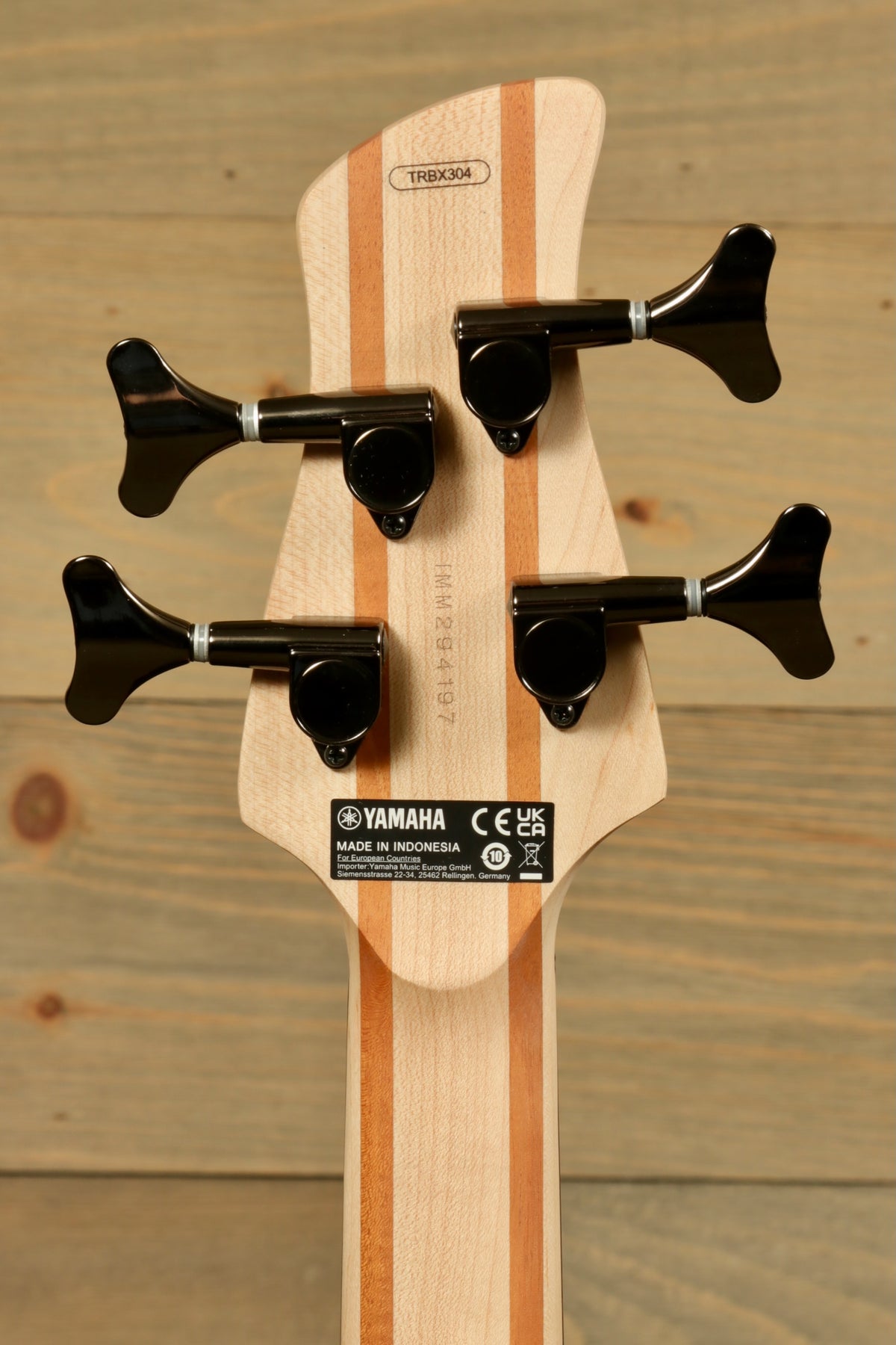 Yamaha electric bass and guitar, back view showing tuning pegs and wood finish