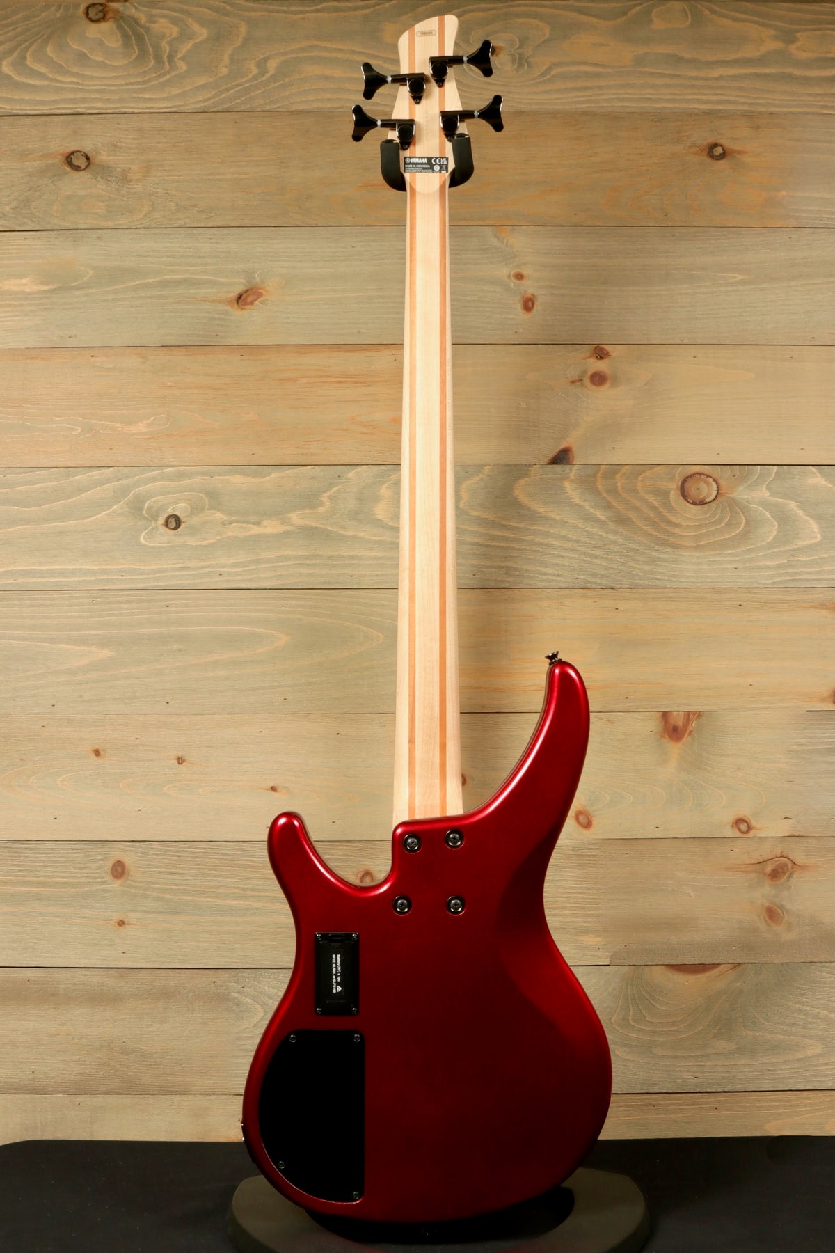 Yamaha electric bass and guitar in metallic red, back view showcasing sleek design and maple neck