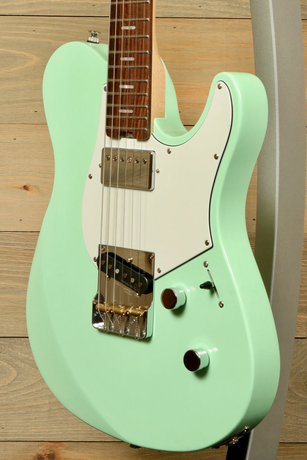 Yamaha Pacifica Peppermint Green electric guitar, side view with white pickguard and chrome knobs