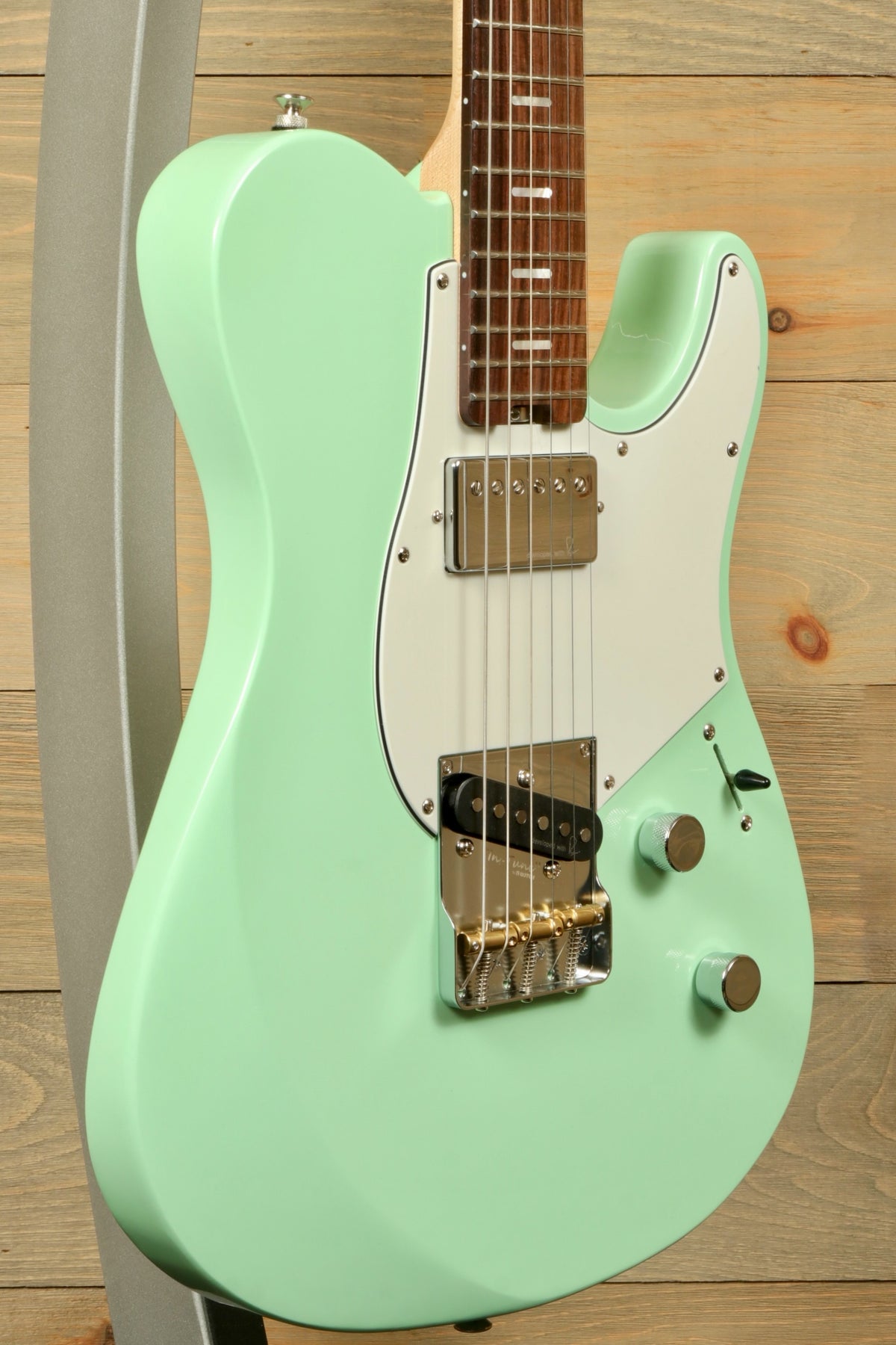 Yamaha Pacifica Peppermint Green electric guitar, side view showcasing its sleek design
