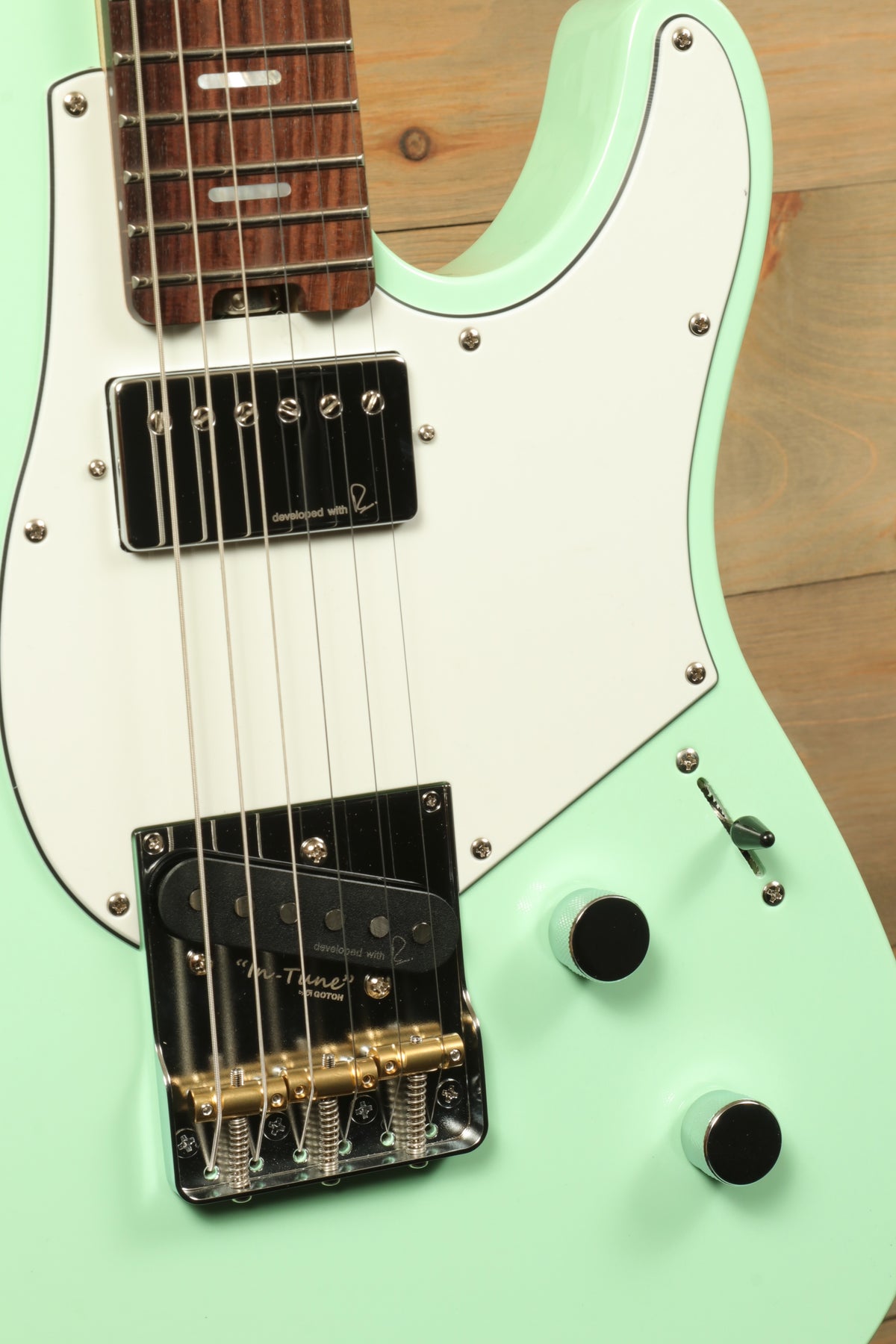 Yamaha Pacifica Peppermint Green electric guitar, close-up view showing body and hardware details