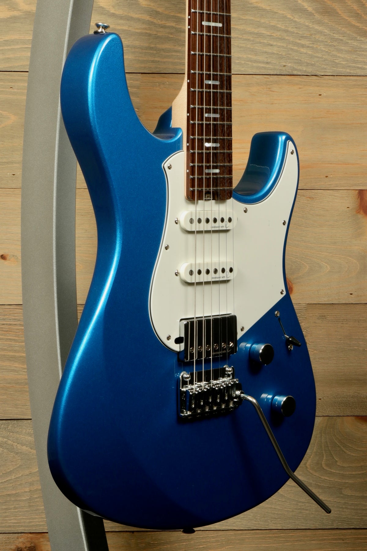 Yamaha Pacifica PACS+12 Standard Plus electric guitar in bright blue, angled view showcasing the sleek design