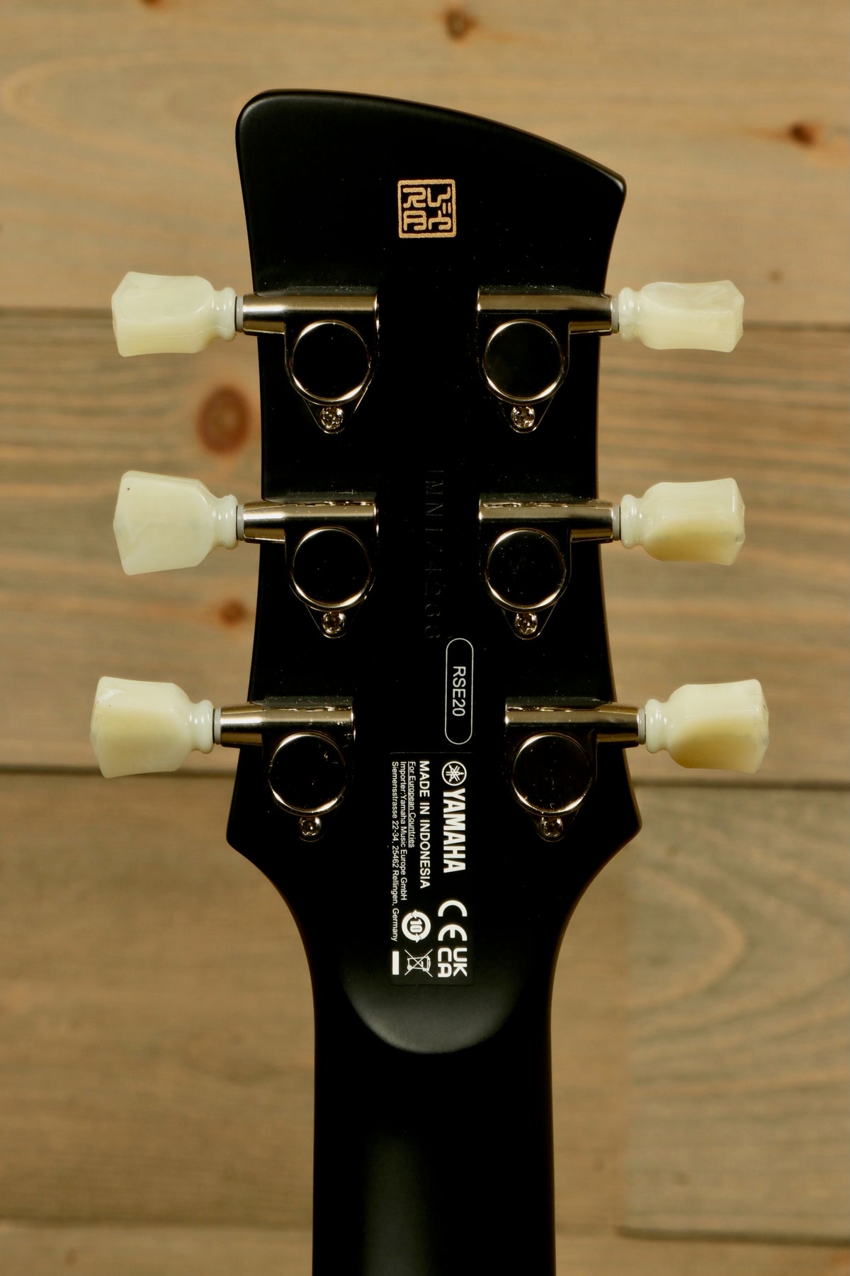 Yamaha Revstar Element RSE20 Electric Guitar Black, headstock view showcasing tuning pegs