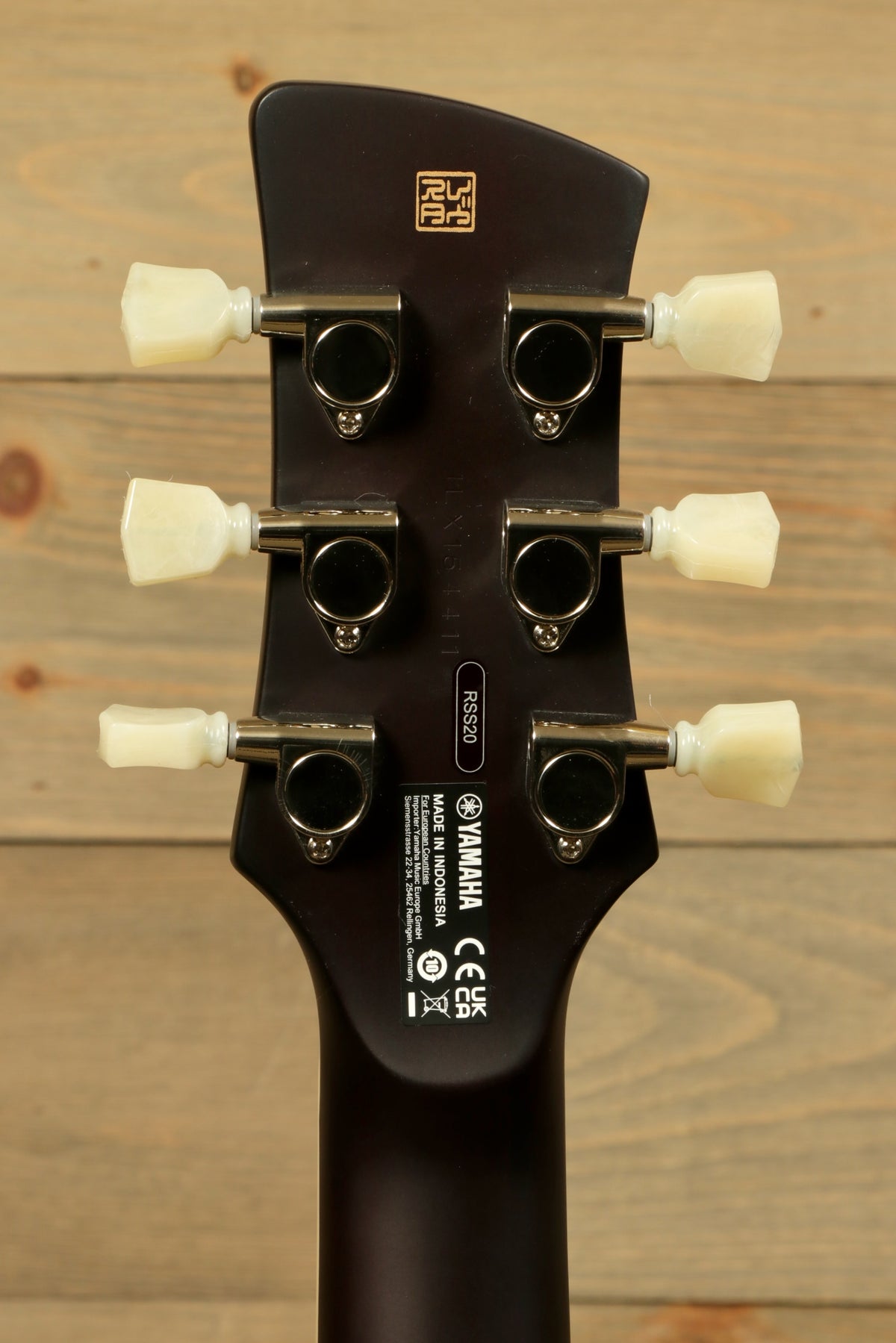 Yamaha Revstar Standard RSS20 headstock in dark finish, rear view showcasing tuning pegs