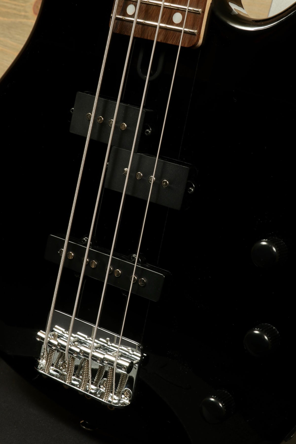 Yamaha TRBX174 bass guitar in black with chrome hardware, close-up view of the strings and pickups