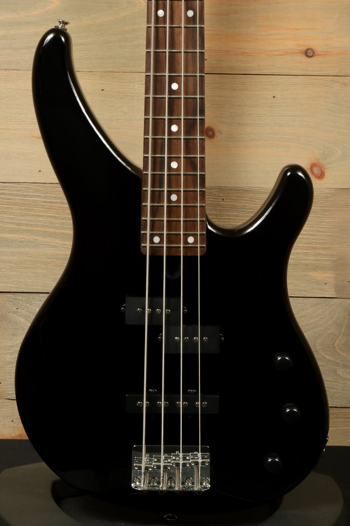 Yamaha TRBX174 black bass guitar, front view showcasing sleek design and full fretboard