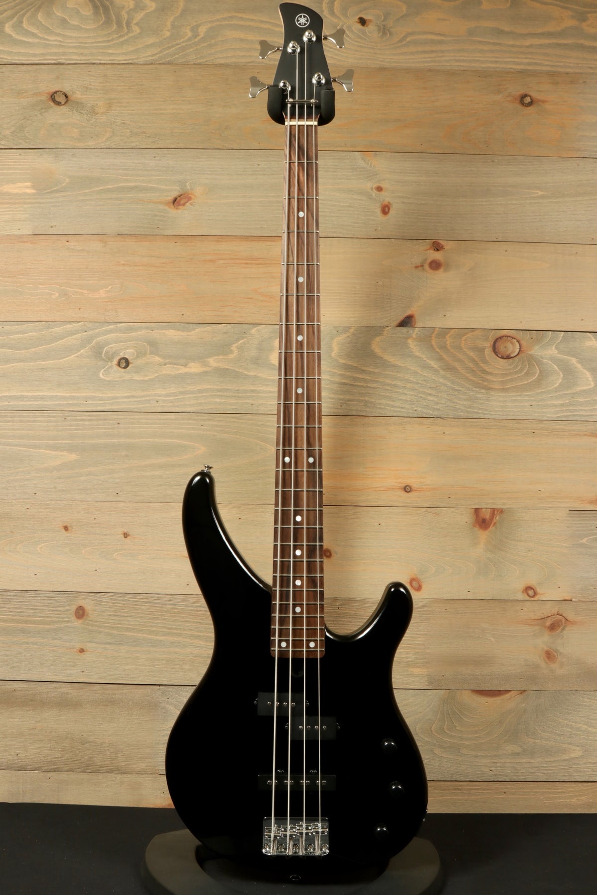 Yamaha TRBX174 black bass guitar, front view with smooth finish and sleek design