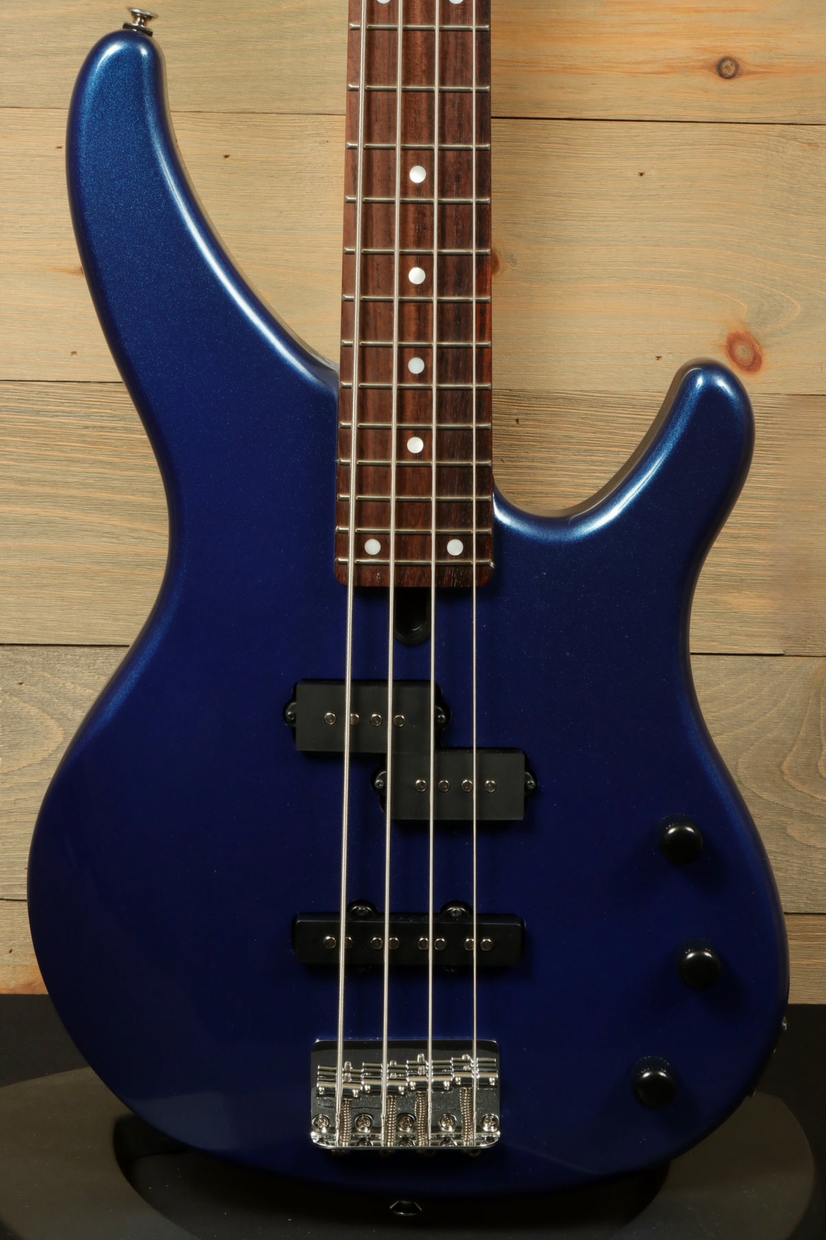Yamaha TRBX174 electric bass guitar in deep blue, front view showcasing the body and fretboard